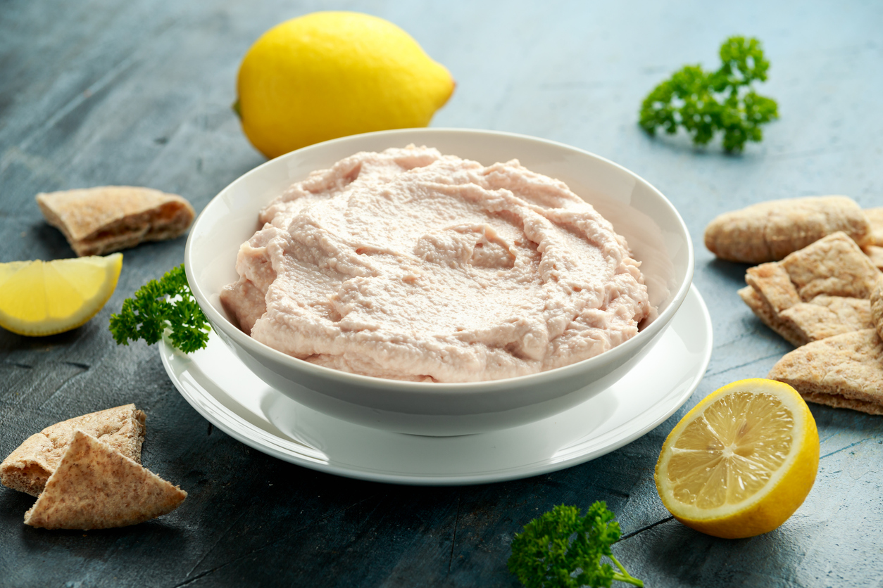 Taramasalata dip made with fish roe in white bowl.