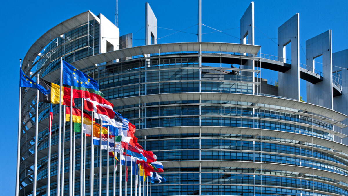 The European Parliament building in Strasbourg, France with flags waving calmly celebrating peace of the Europe