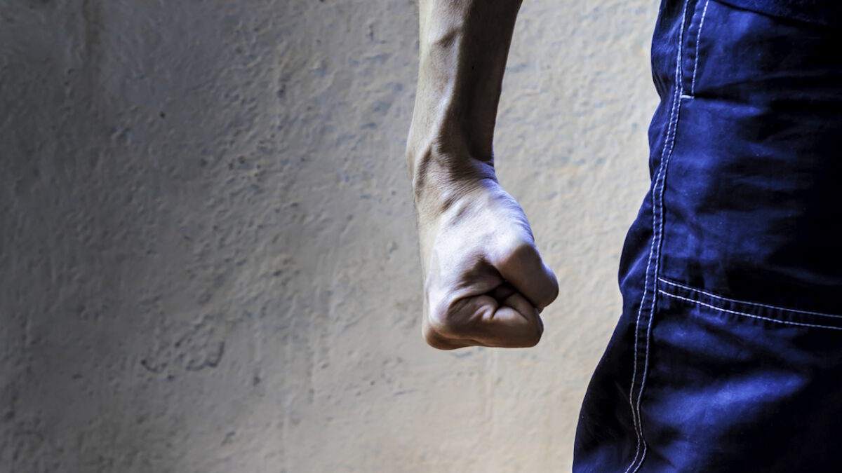 man closing his hand tightly. Clenched fist. Hand gesture. Fight, strength and determination concept.