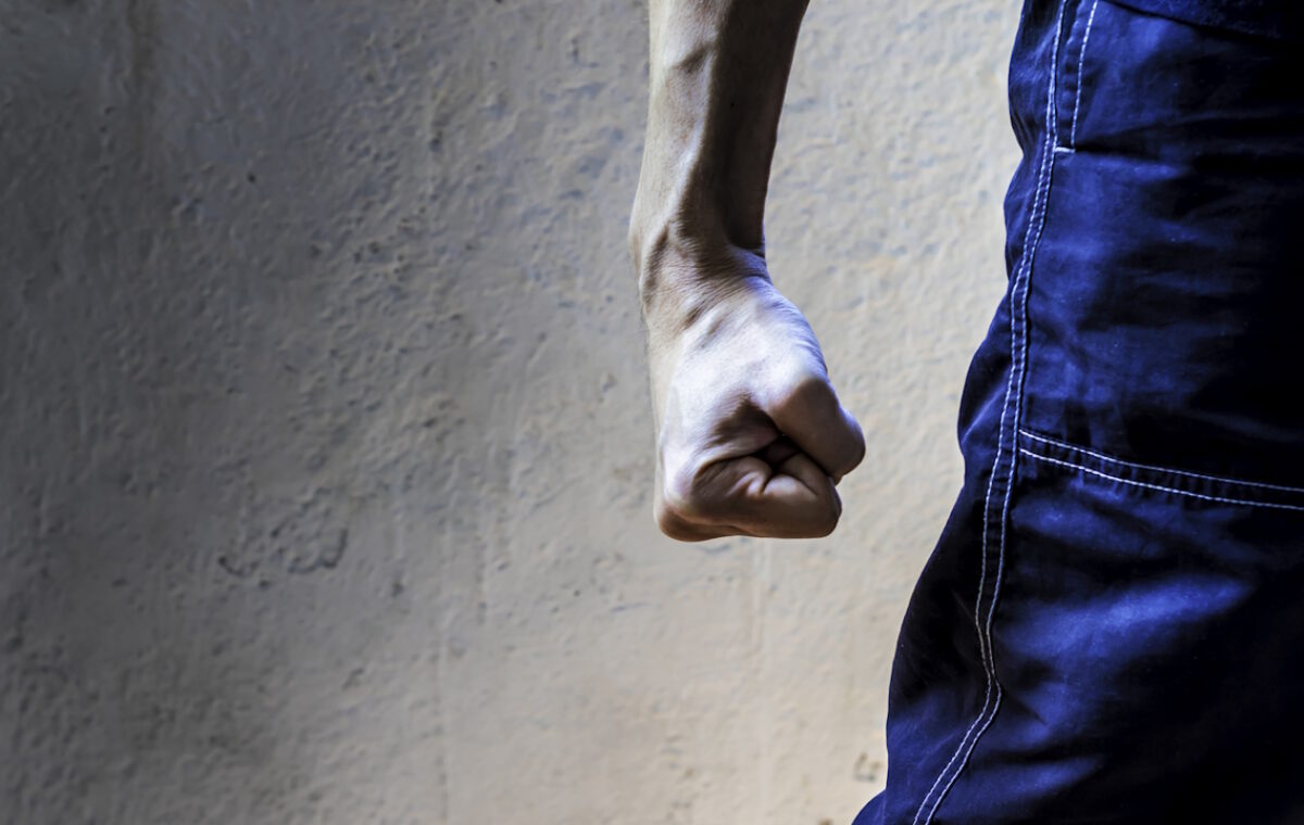 man closing his hand tightly. Clenched fist. Hand gesture. Fight, strength and determination concept.