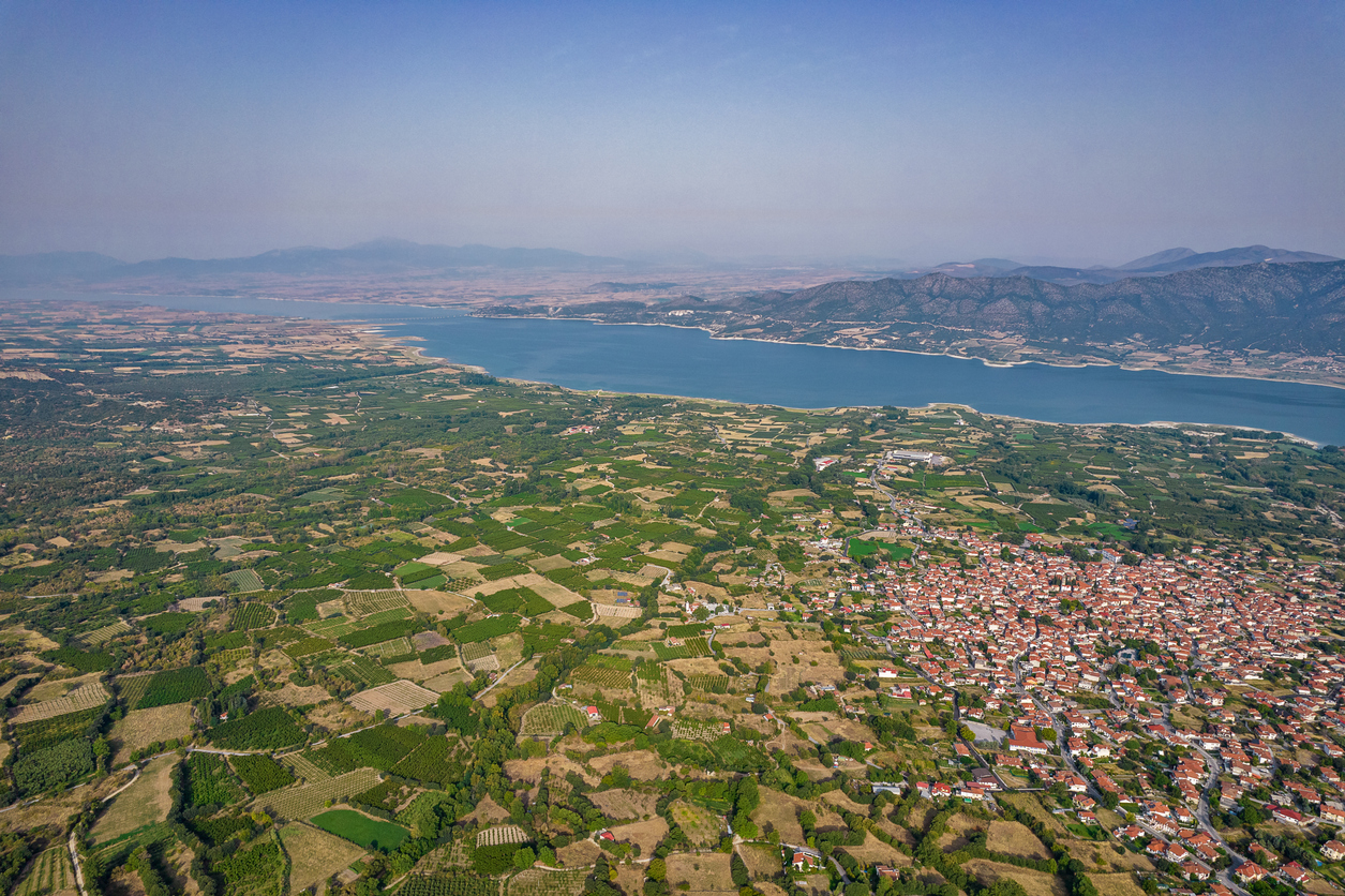 Aerial drone morning view over Polyfytos artificial lake and Velventos village. Larissa, Greece.