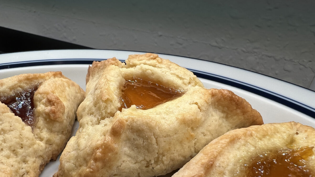 Close-up of apricot hamantaschen cookies for the Jewish holiday of Purim on a white plate, Lafayette, California, March 10, 2022. Photo courtesy Sftm