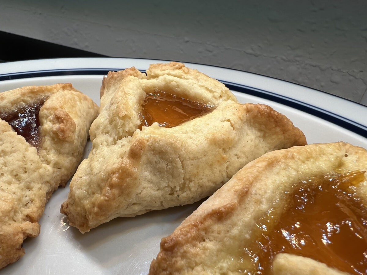 Close-up of apricot hamantaschen cookies for the Jewish holiday of Purim on a white plate, Lafayette, California, March 10, 2022. Photo courtesy Sftm