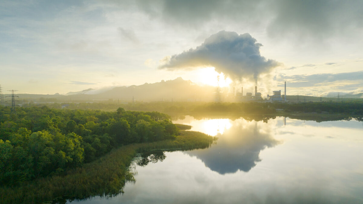Aerial view coal power plant station in the morning mist, the morning sunrises. coal power plant and environment concept. Coal and steam. Mae Moh, Lampang, Thailand.