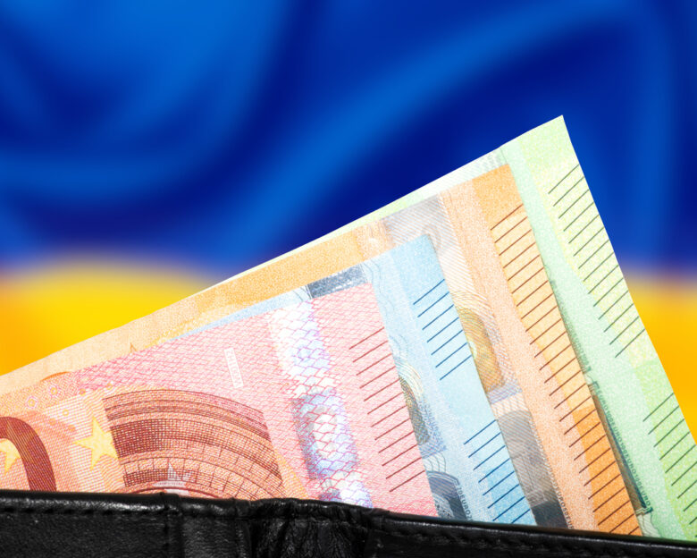 Flag of Ukraine and wallet with euro banknotes