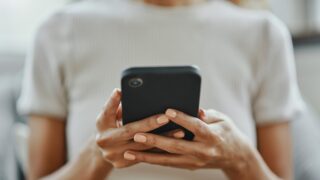 Home woman hands, social media and phone contact, communication and smartphone technology in living room. Closeup mobile app multimedia, reading internet fake news online and 5g web social networking