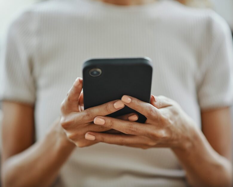 Home woman hands, social media and phone contact, communication and smartphone technology in living room. Closeup mobile app multimedia, reading internet fake news online and 5g web social networking