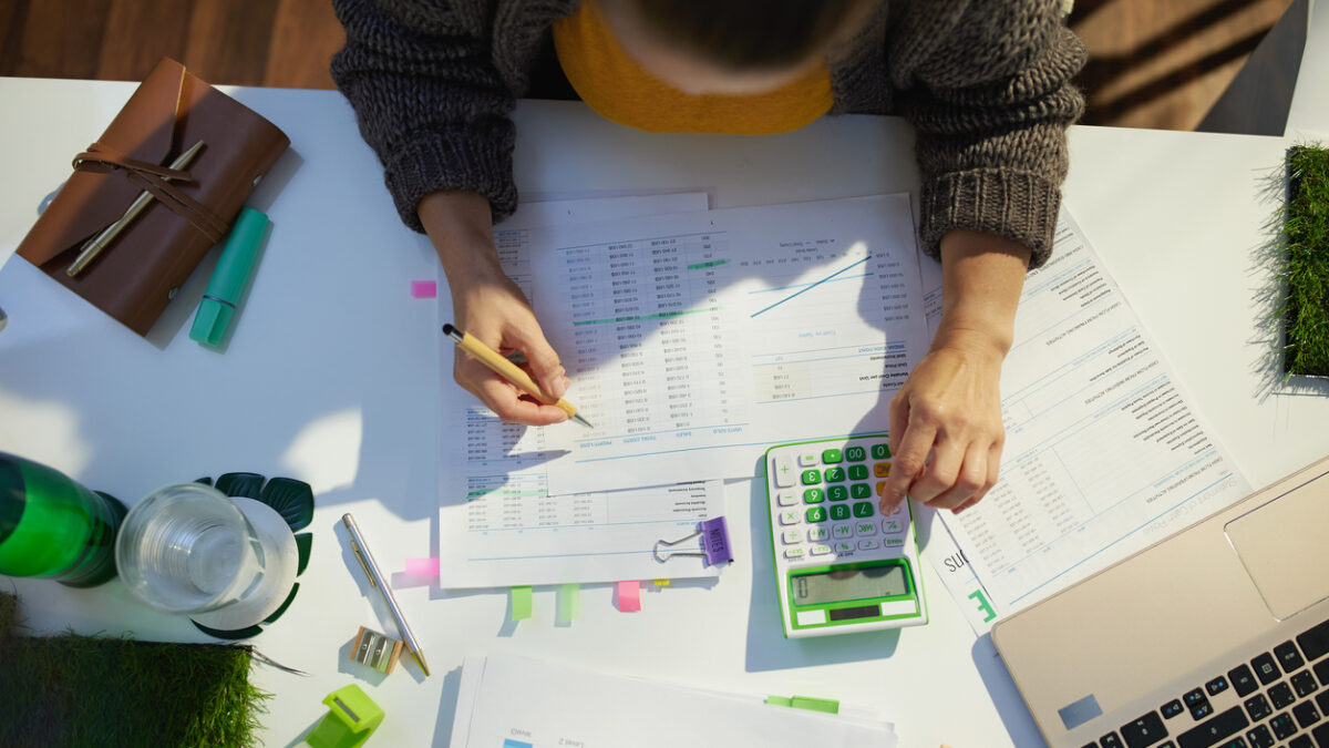 accountant woman with calculator and documents working in office