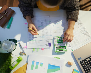 accountant woman with calculator and documents working in office
