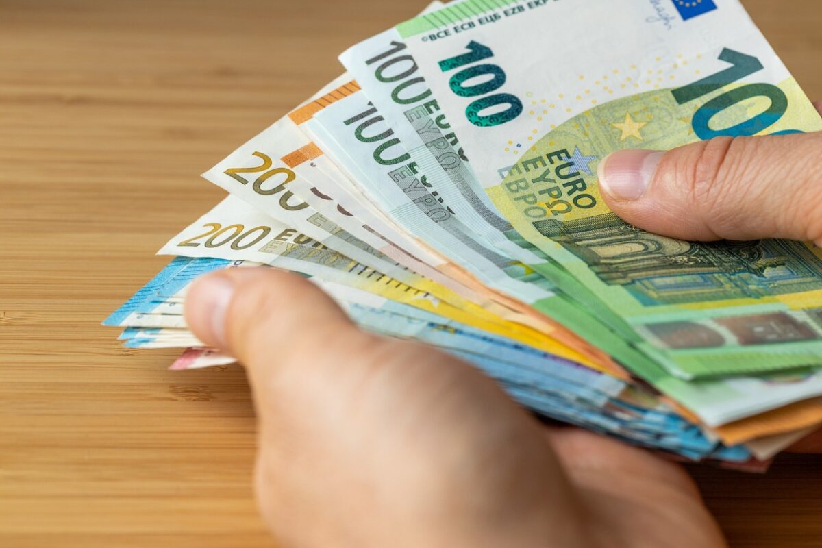 Bundles of euro money, bundle of banknotes held in a hand, Financial concept, Euro zone, Currency of the European Union