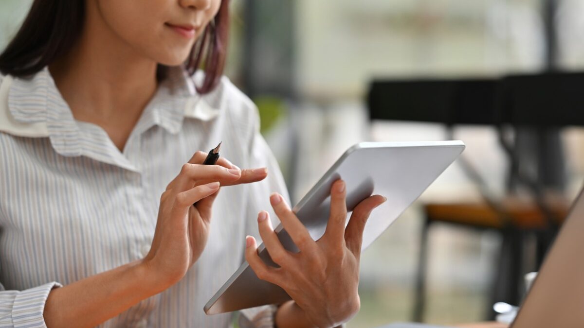 Close up or cropped image of Business and financial woman using tablet and laptop for working.