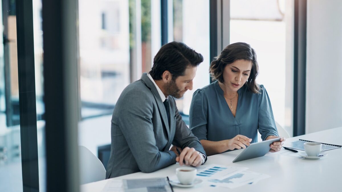 Business people, teamwork and tablet for statistics, finance report and planning of revenue, profit or sales in office. Professional advisor or clients with data analytics, graphs and digital charts