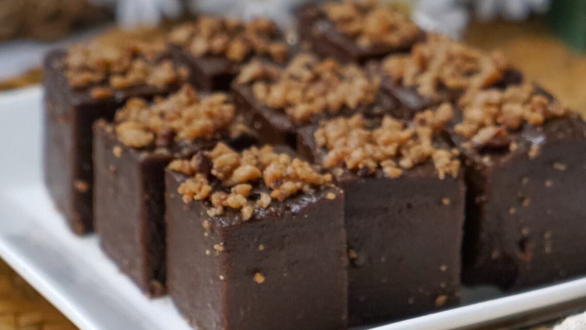 Kuih kole kacang, a steamed Malaysian cake, made with fried green bean flour, coconut milk, and palm sugar. The decoration of the cake is from coconut oil grease or residue. Selective focus.