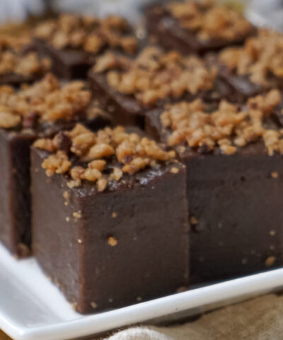 Kuih kole kacang, a steamed Malaysian cake, made with fried green bean flour, coconut milk, and palm sugar. The decoration of the cake is from coconut oil grease or residue. Selective focus.