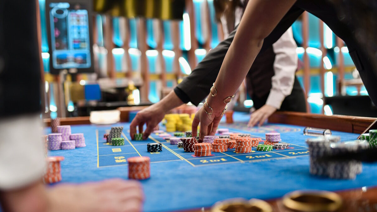 Female and Male Having Fun in Luxurious Casino Rearranging Gambling Chips