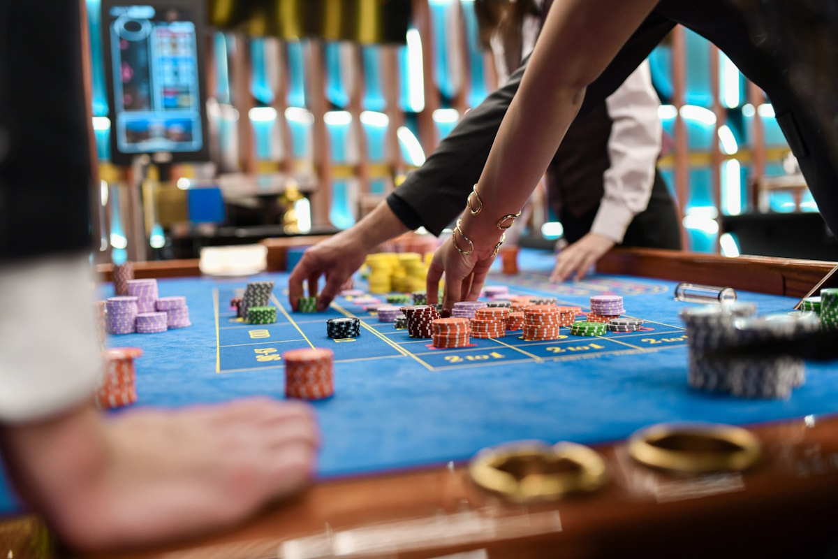 Female and Male Having Fun in Luxurious Casino Rearranging Gambling Chips