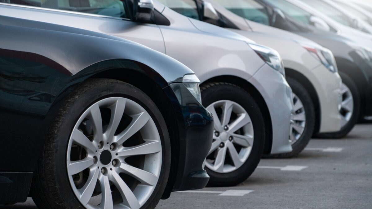 A lot of cars in a rows. Used car sales.