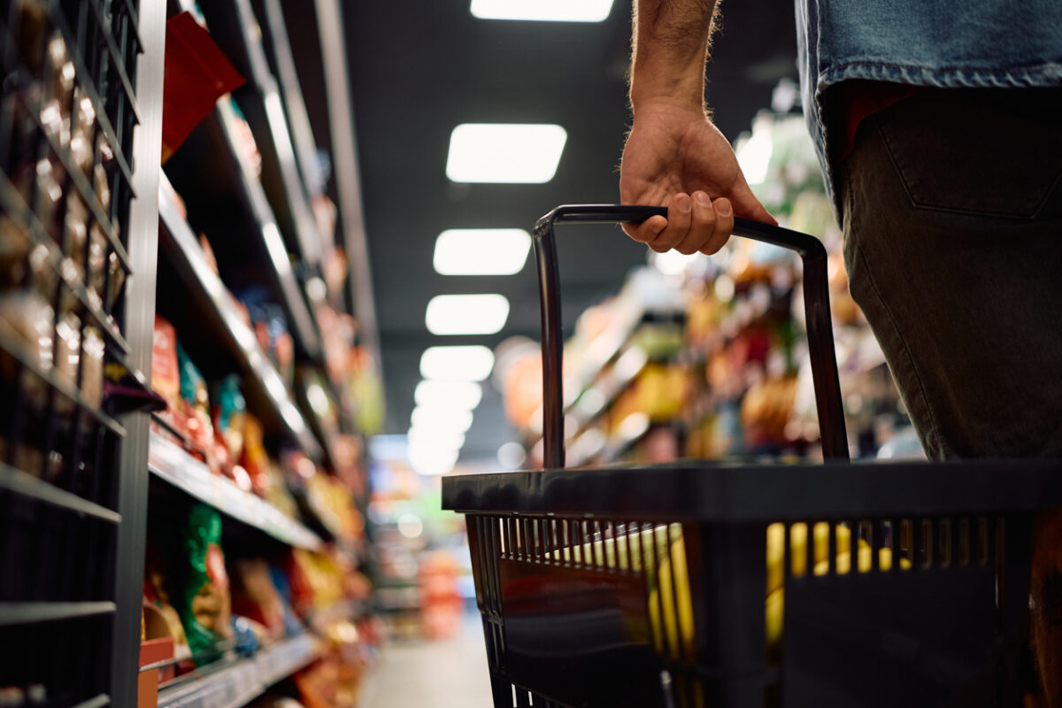 Close up of man buying groceries in supermarket. Copy space.