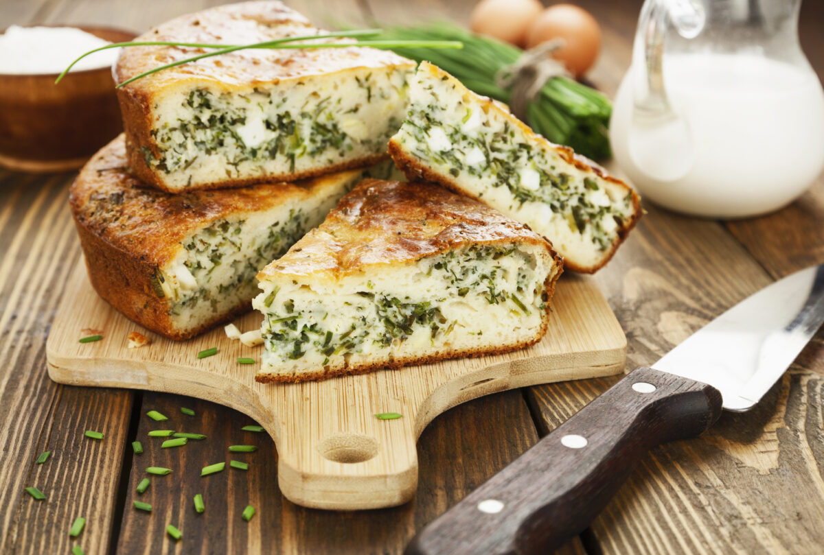 Pie with spring onion and eggs on the tablePie with spring onion and eggs on the table