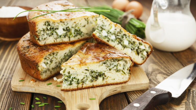 Pie with spring onion and eggs on the tablePie with spring onion and eggs on the table