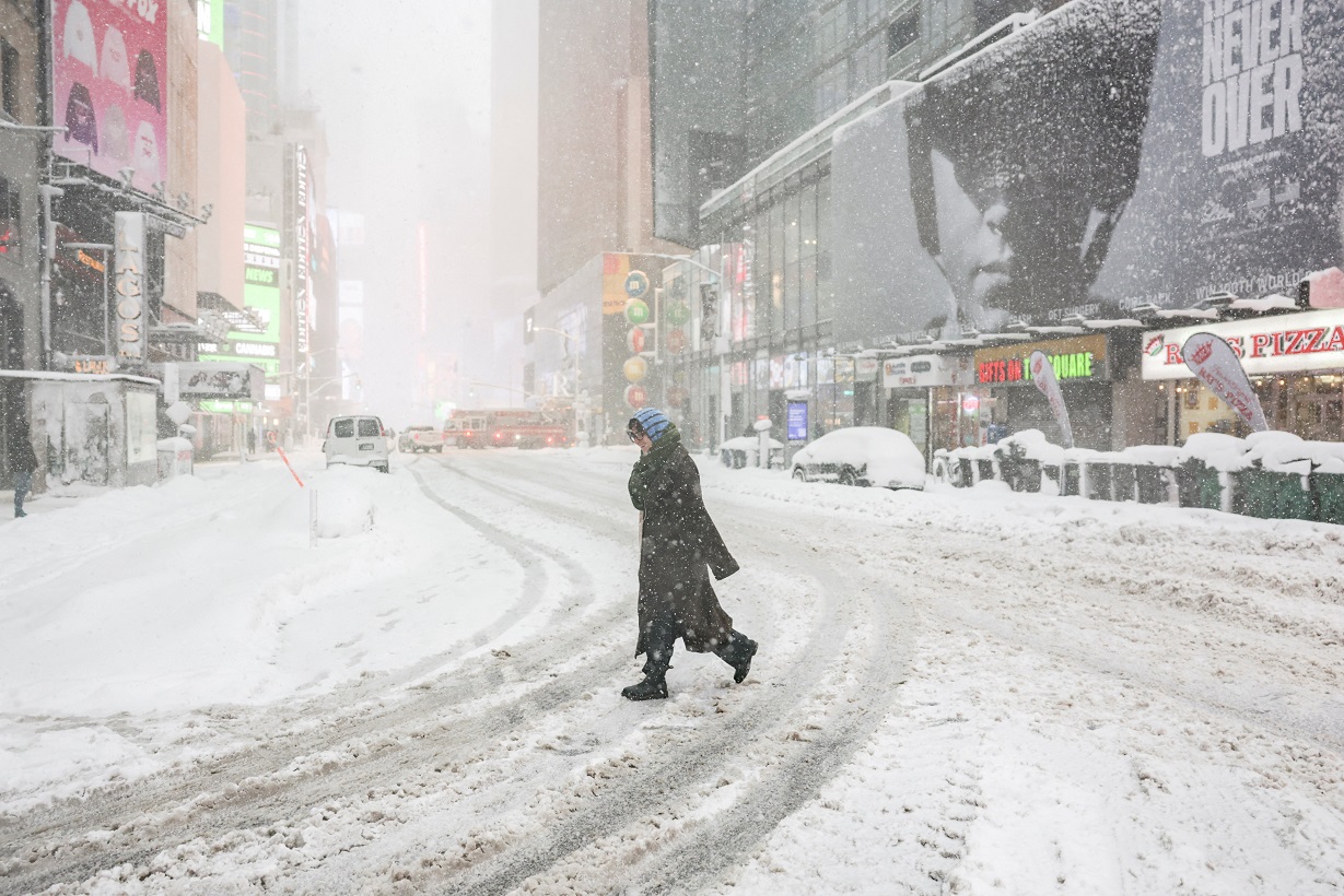A pedestrian walks on a street as snow falls during a winter storm in New York City, U.S., February 23, 2026. REUTERS
