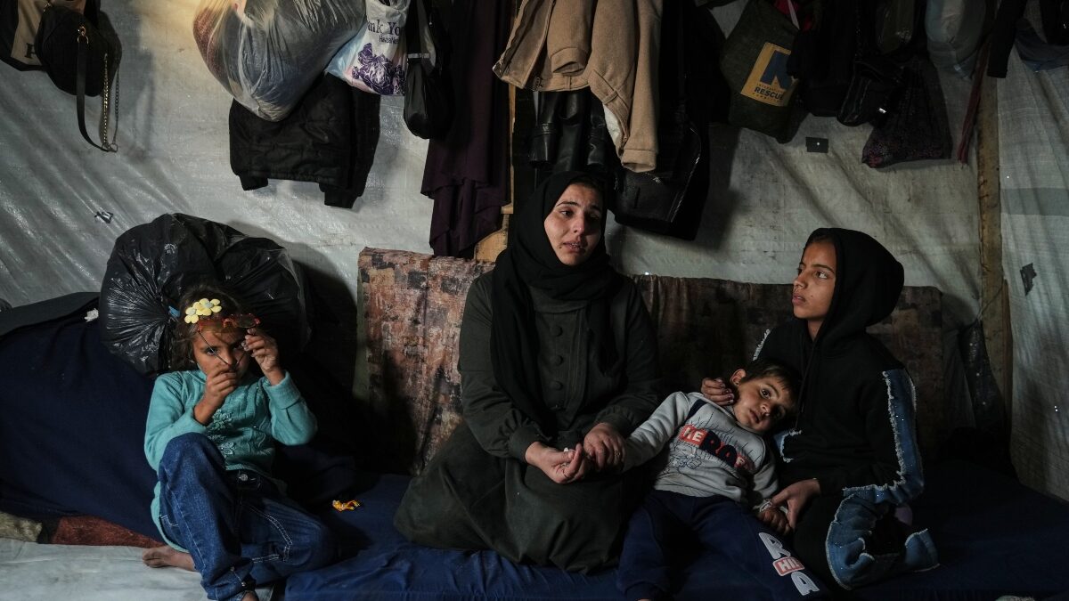 Rotana al-Regeb, who was allowed into Gaza from Egypt following the long-awaited reopening of the Rafah border crossing, reunites with her children in Khan Younis, southern Gaza Strip, Tuesday, Feb. 3, 2026. (AP Photo/Jehad Alshrafi)