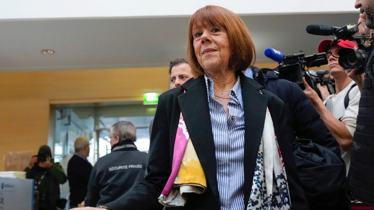 FILE - Gisele Pelicot, who was allegedly drugged by her now former husband so that he and others could assault her, arrives at the court house wearing a scarf printed with artwork of Martu woman, Mulyatingki Marney, in Avignon, southern France, on Dec. 19, 2024.