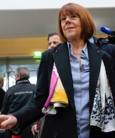 FILE - Gisele Pelicot, who was allegedly drugged by her now former husband so that he and others could assault her, arrives at the court house wearing a scarf printed with artwork of Martu woman, Mulyatingki Marney, in Avignon, southern France, on Dec. 19, 2024.