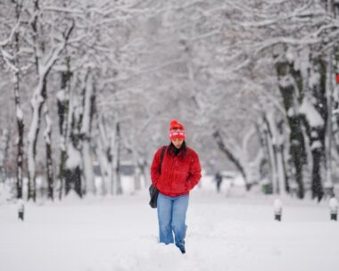 A woman trudges through snow after a blizzard in Bucharest, Romania, Wednesday, Feb. 18, 2026. (AP Photo/Vadim Ghirda)