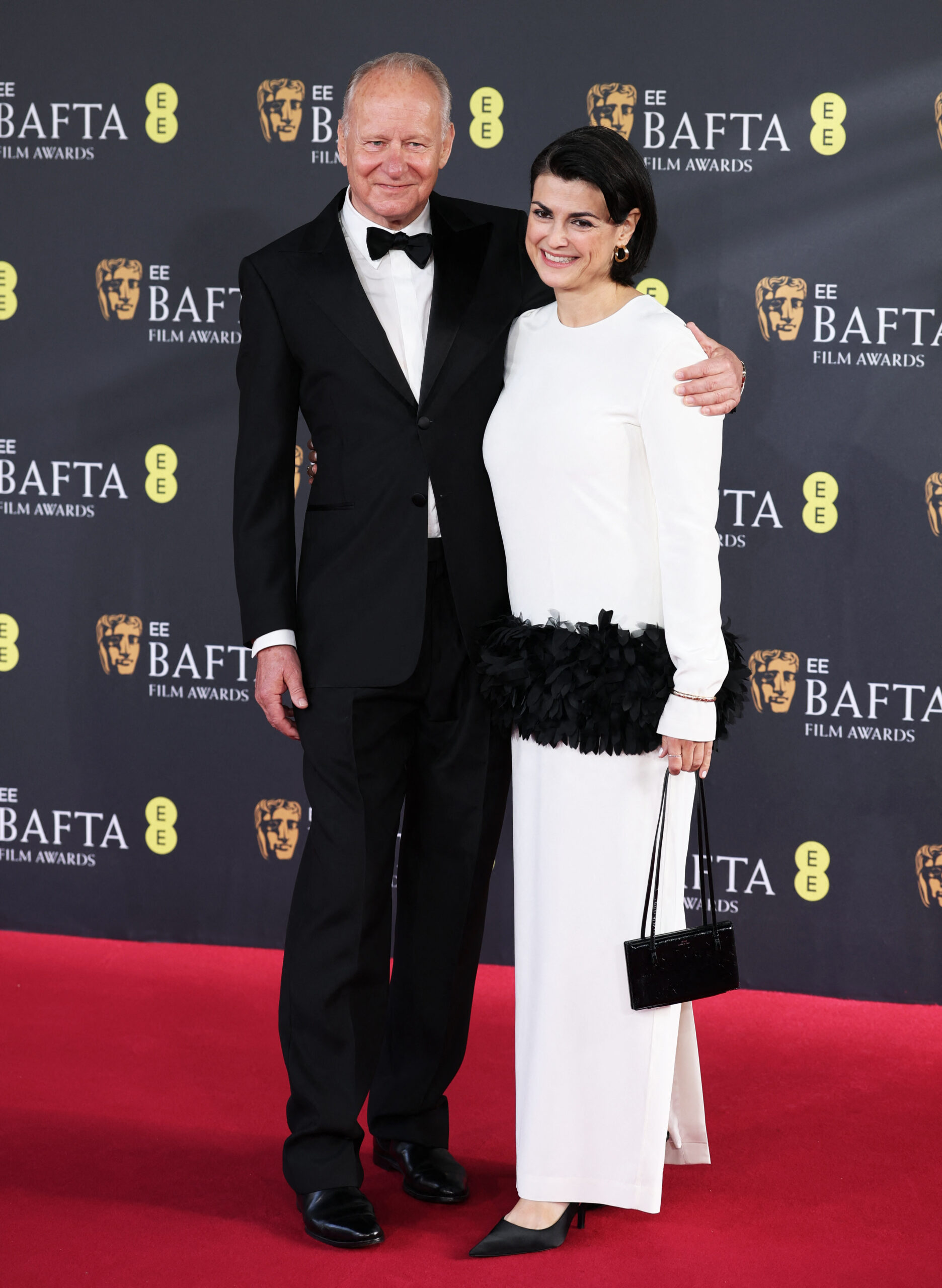 Stellan Skarsgard and Megan Everett-Skarsgard pose on the red carpet during the 2026 British Academy of Film and Television Awards (BAFTA) at the Royal Festival Hall in the Southbank Centre, London, Britain, February 22, 2026. REUTERS