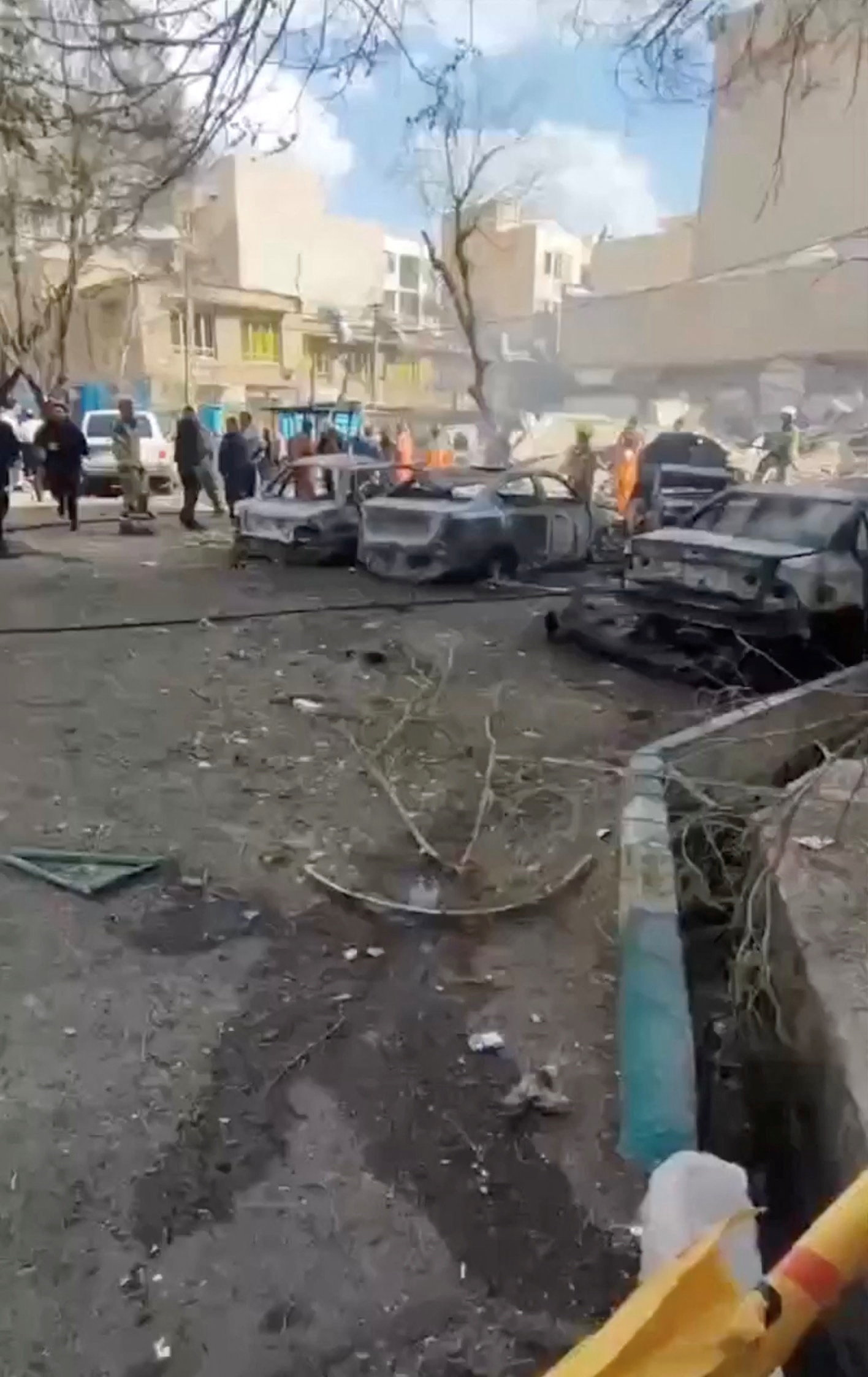 Aftermath of strike in Tehran People gather near burnt vehicles in Tehran, Iran, in this screengrab obtained from social media video released on February 28, 2026. Israel and the U.S. conducted strikes on Iran on Saturday. Social Media/via REUTERS THIS IMAGE HAS BEEN SUPPLIED BY A THIRD PARTY. MANDATORY CREDIT. NO RESALES. NO ARCHIVES. NEWS USE ONLY. Verification: Reuters confirmed the location of the videos as Tehran from the buildings, numbered sign, road layout and curb which matched file and satellite imagery of the area. Reuters was not able to verify the exact time when the videos were filmed.