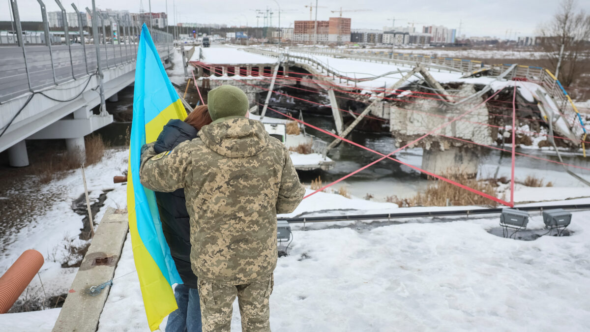 People attend a memorial event to mark the fourth anniversary of the full-scale Russian invasion, amid Russia's attack on Ukraine, at Romanivskyi Bridge, which was destroyed at the beginning of the war and which was the main way for evacuations of civilians from the front line area around the Ukrainian capital, in Irpin, outside of Kyiv, Ukraine February 24, 2026. REUTERS/Gleb Garanich TPX IMAGES OF THE DAY