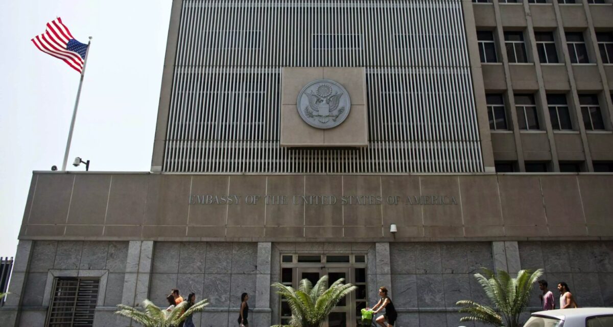 Pedestrians walk past the U.S. embassy in Tel Aviv August 2, 2013. U.S. embassies that would normally be open this Sunday - including those in Abu Dhabi, Baghdad and Cairo - will be closed that day because of unspecified security concerns, the U.S. State Department said on Thursday. CBS News said U.S. embassies would also be closed in Bahrain, Israel, Jordan, Kuwait, Libya, Oman, Qatar, Saudi Arabia, Yemen, Afghanistan and Bangladesh. REUTERS/Nir Elias (ISRAEL - Tags: POLITICS)