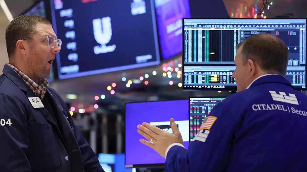 Traders work on the floor at the New York Stock Exchange (NYSE) in New York City, U.S., December 1, 2023.