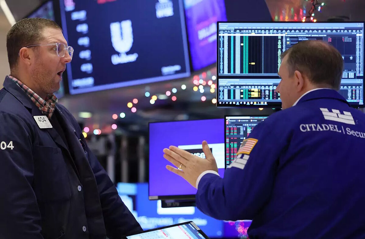 Traders work on the floor at the New York Stock Exchange (NYSE) in New York City, U.S., December 1, 2023.