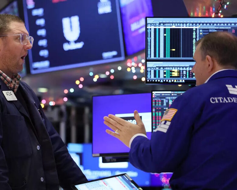 Traders work on the floor at the New York Stock Exchange (NYSE) in New York City, U.S., December 1, 2023.