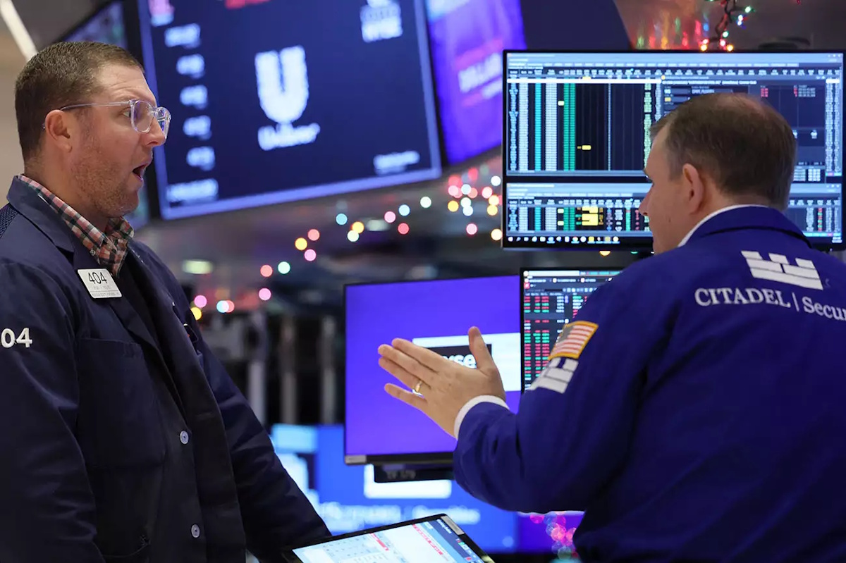 Traders work on the floor at the New York Stock Exchange (NYSE) in New York City, U.S., December 1, 2023.