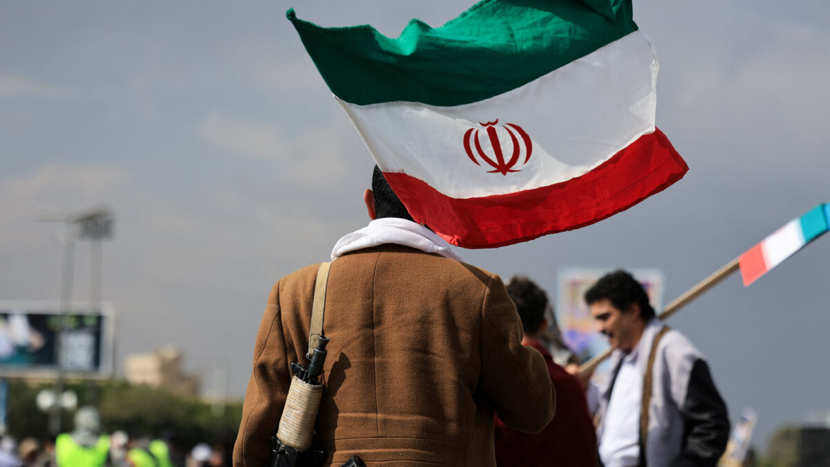 A person walks with an Iranian flag during a protest against Israel and the U.S. strikes on Iran, following the killing of Ali Khamenei, in Sanaa, Yemen, March 1, 2026. REUTERS/Khaled Abdullah
