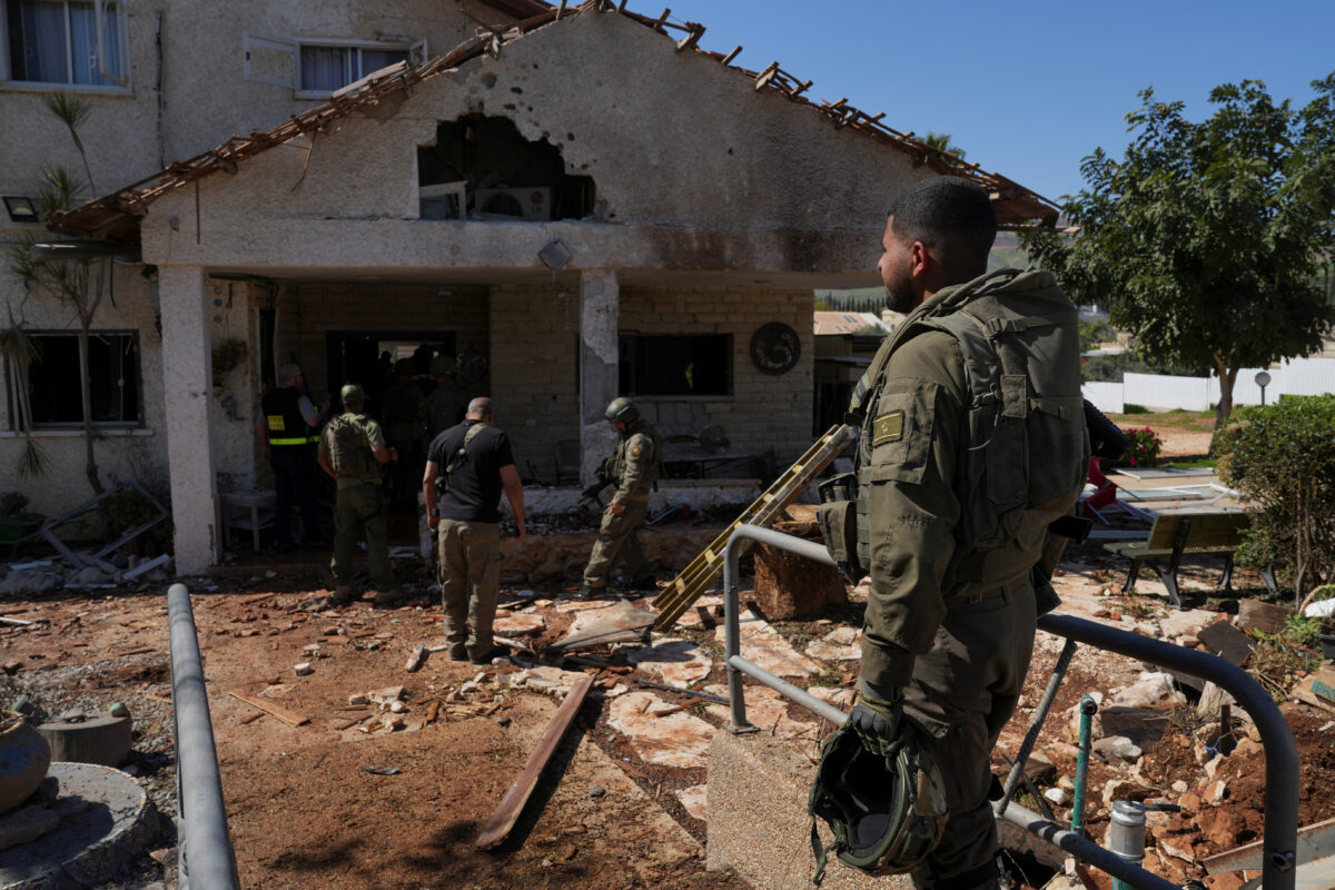 Israeli soldiers work at a house that was damaged by a barrage of rockets fired by Lebanon's Iran-backed Hezbollah into Israel, amid the U.S.-Israel conflict with Iran, near Israel's border with Lebanon in northern Israel, March 3, 2026. REUTERS/Ayal Margolin ISRAEL OUT. NO COMMERCIAL OR EDITORIAL SALES IN ISRAEL