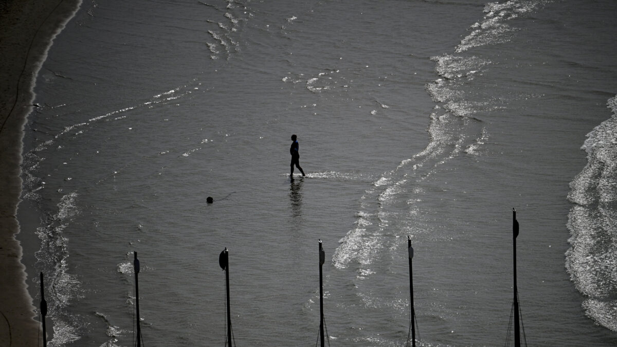 A person walks on the beach, amid the U.S.-Israeli conflict with Iran, in Tel Aviv, Israel, March 6, 2026. REUTERS/Dylan Martinez
