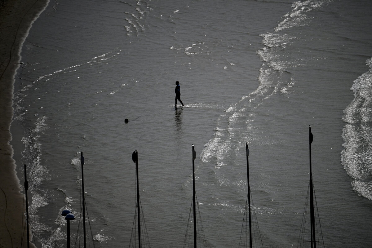 A person walks on the beach, amid the U.S.-Israeli conflict with Iran, in Tel Aviv, Israel, March 6, 2026. REUTERS/Dylan Martinez