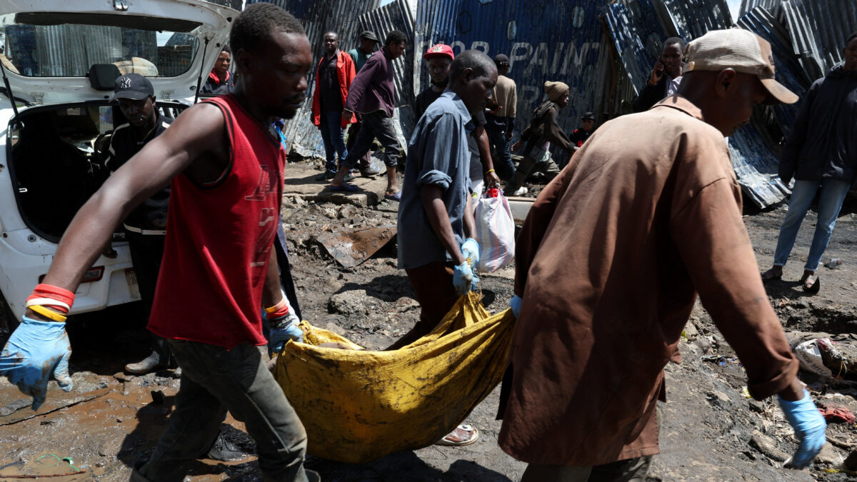 Volunteers carry the body of a person killed by flooding following heavy rainfall in the Grogan area, popular for automotive workshops and secondhand spare parts, in downtown Nairobi, Kenya, March 7, 2026. REUTERS/Monicah Mwangi