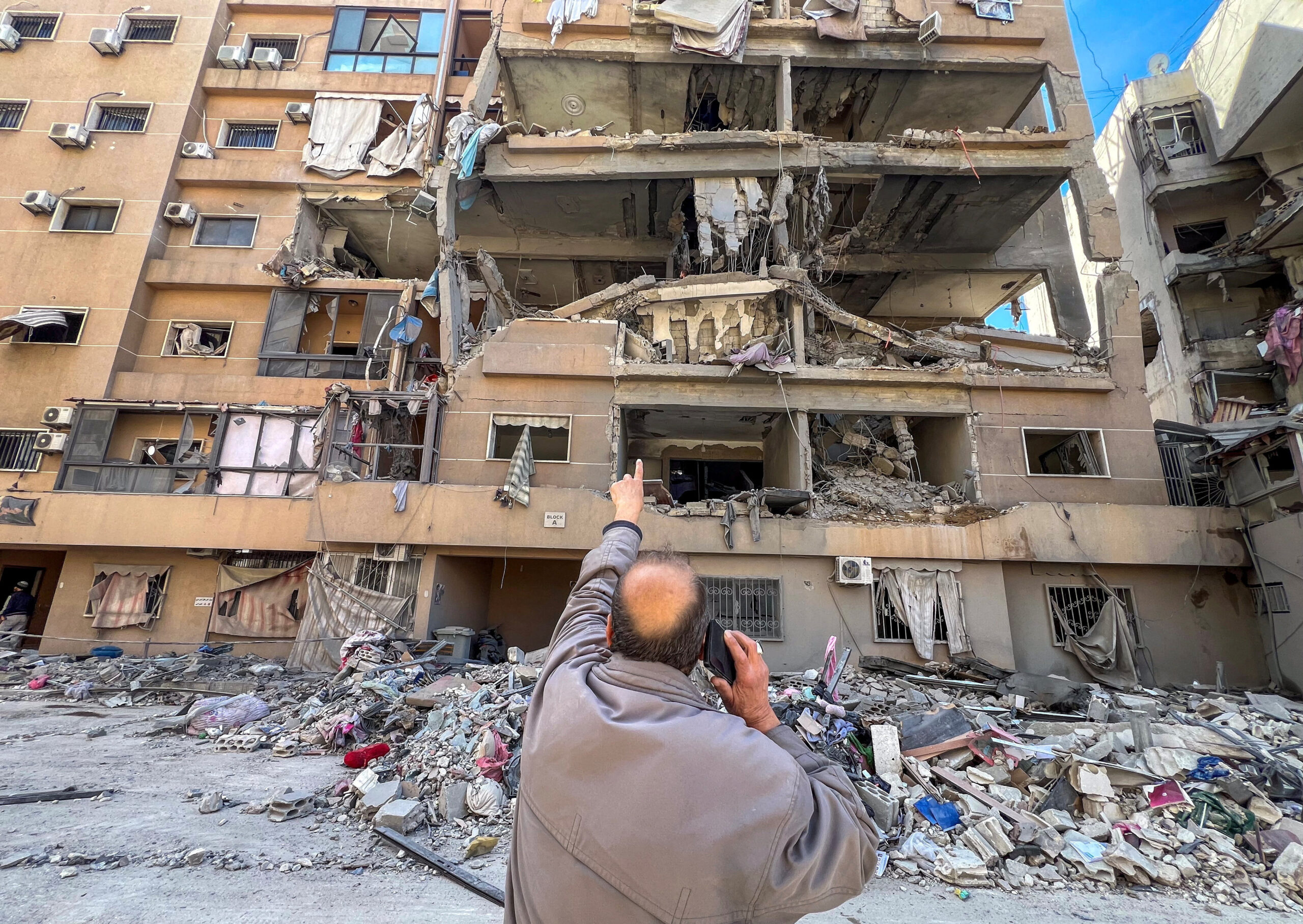Israeli strikes in Beirut southern suburbs A man points at a building damaged by Israeli strikes, amid escalating hostilities between Israel and Hezbollah, as the U.S.-Israeli conflict with Iran continues, in Beirut's southern suburbs, Lebanon, March 28, 2026. Picture taken with a mobile phone. REUTERS/Stringer TPX IMAGES OF THE DAY