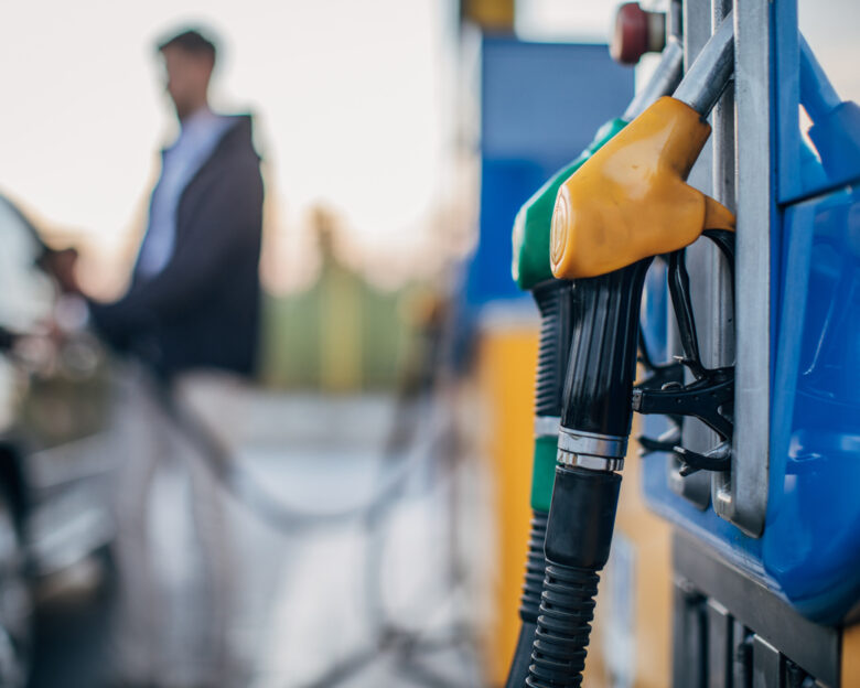 One man, pouring gasoline in his car at the gas station.