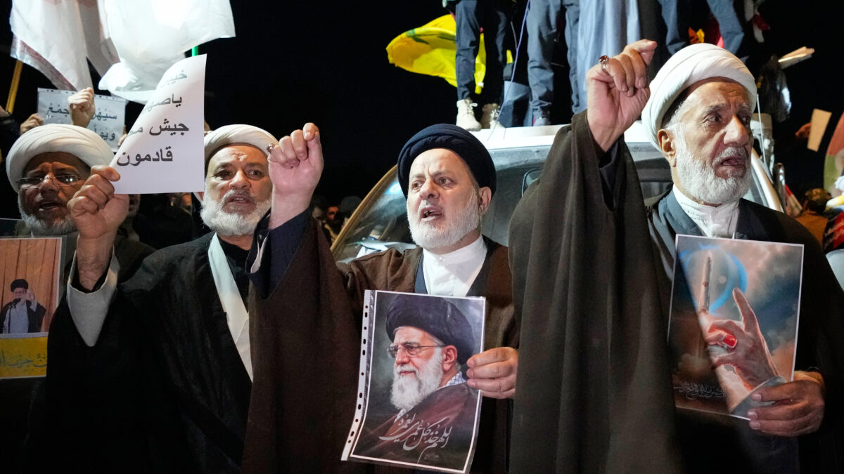 Iraqi Shiite clerics hold a portrait of Iran's Supreme Leader Ayatollah Ali Khamenei during a protest against U.S. and Israeli attacks on multiple cities across Iran at a bridge leading to the fortified Green Zone where the U.S. embassy is located in Baghdad, Iraq, Saturday, Feb. 28, 2026. (AP Photo/Hadi Mizban)