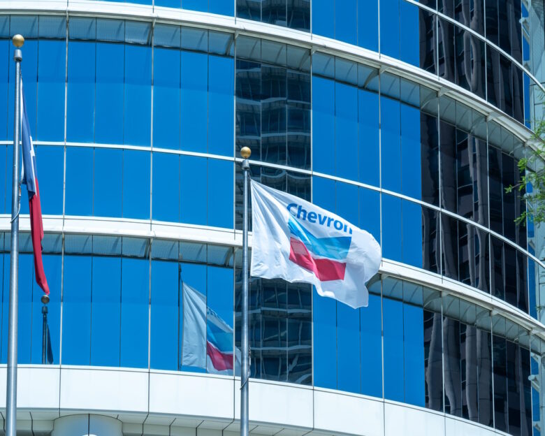 Houston, Texas, USA - April 4, 2024: The flags at Chevron Corporation office building in Houston, Texas, USA. Chevron Corporation is an American multinational energy corporation.