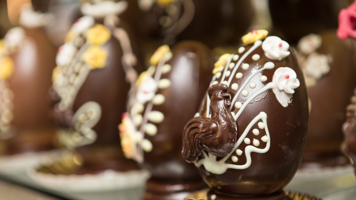 Close up on chocolate easter egg ornate with chocolate carvings.