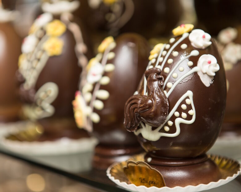 Close up on chocolate easter egg ornate with chocolate carvings.