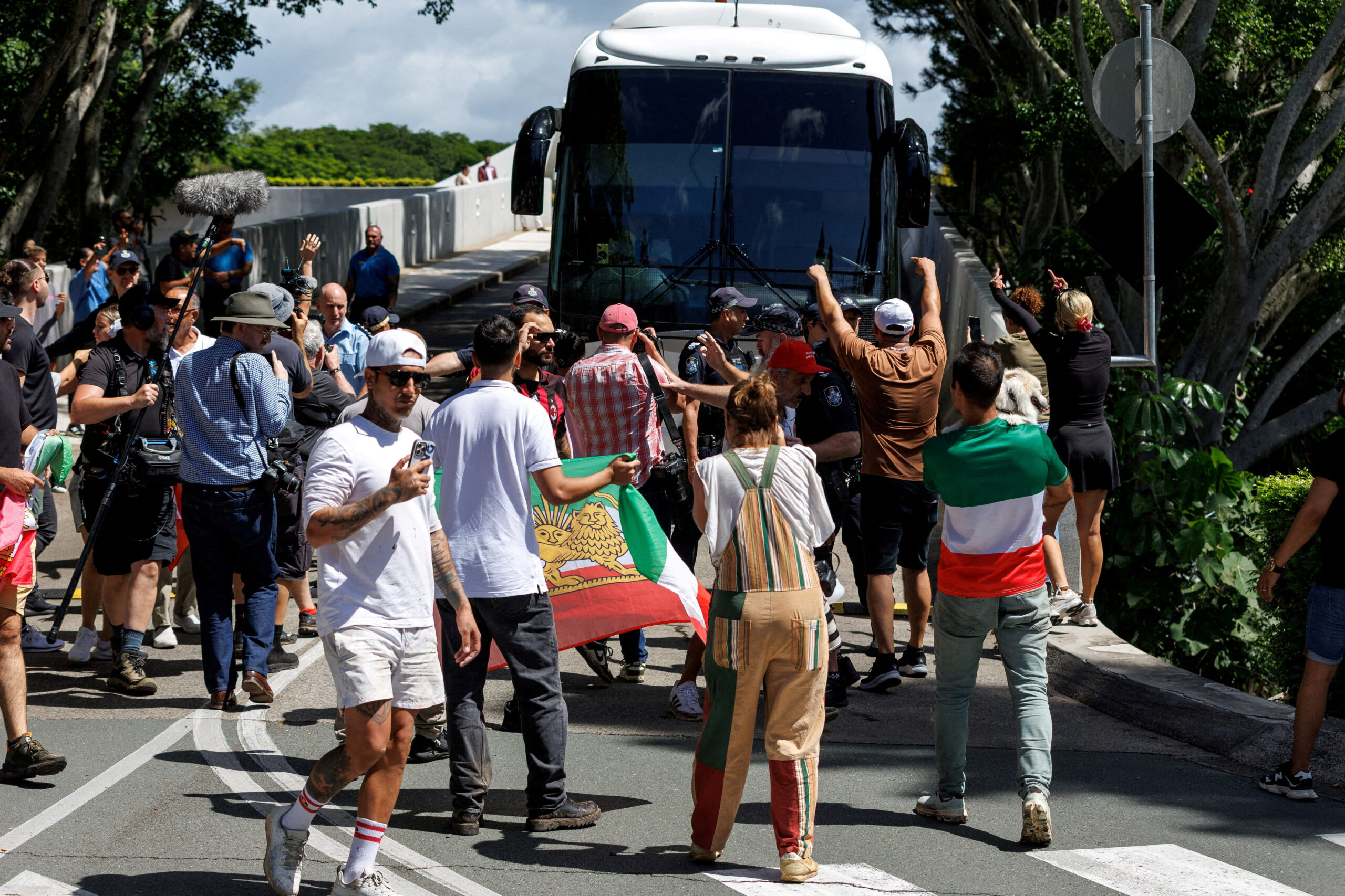 Protesters demonstrate outside of Royal Pines resort as a bus carrying players from the Iranian women’s soccer team and staff departs, on the Gold Coast, Queensland SENSITIVE MATERIAL. THIS IMAGE MAY OFFEND OR DISTURB Protesters demonstrate outside of Royal Pines resort as a bus carrying players from the Iranian women's soccer team and staff departs, after five Iranian women soccer players were granted humanitarian visas, on the Gold Coast, Queensland, Australia, March 10, 2026. AAP/Russell Freeman via REUTERS ATTENTION EDITORS - THIS IMAGE WAS PROVIDED BY A THIRD PARTY. NO RESALES. NO ARCHIVE. AUSTRALIA OUT. NEW ZEALAND OUT. NO COMMERCIAL OR EDITORIAL SALES IN NEW ZEALAND. NO COMMERCIAL OR EDITORIAL SALES IN AUSTRALIA. TPX IMAGES OF THE DAY