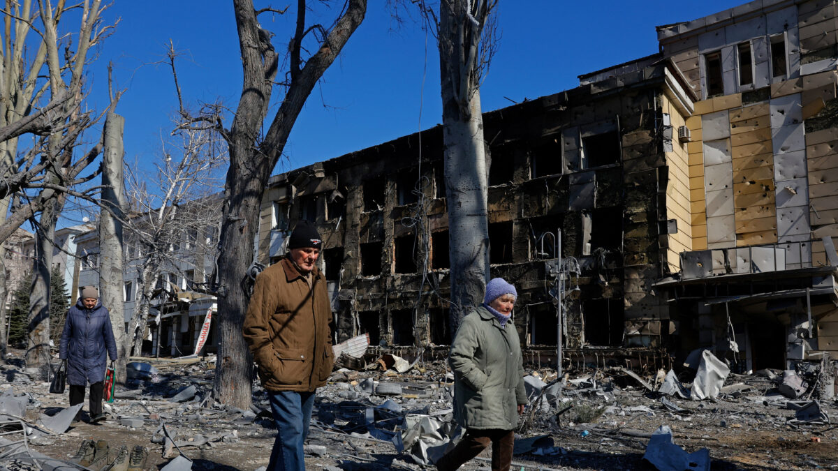 People walk past a building of a children's hospital, damaged yesterday by shelling that local Russian-installed authorities called a Ukrainian military strike, while the hospital was under maintenance with no patients inside, in the course of the Russia-Ukraine military conflict in Donetsk, a Russian-controlled city of Ukraine, March 9, 2026. REUTERS/Alexander Ermochenko